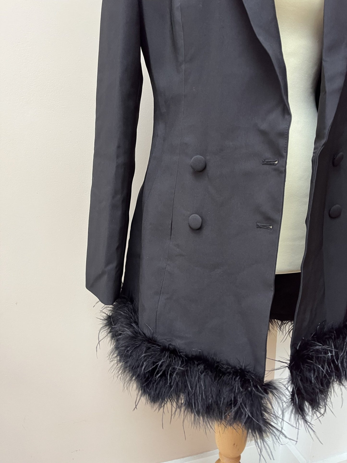 Black tuxedo style dress or jacket with feather hem. Size 12