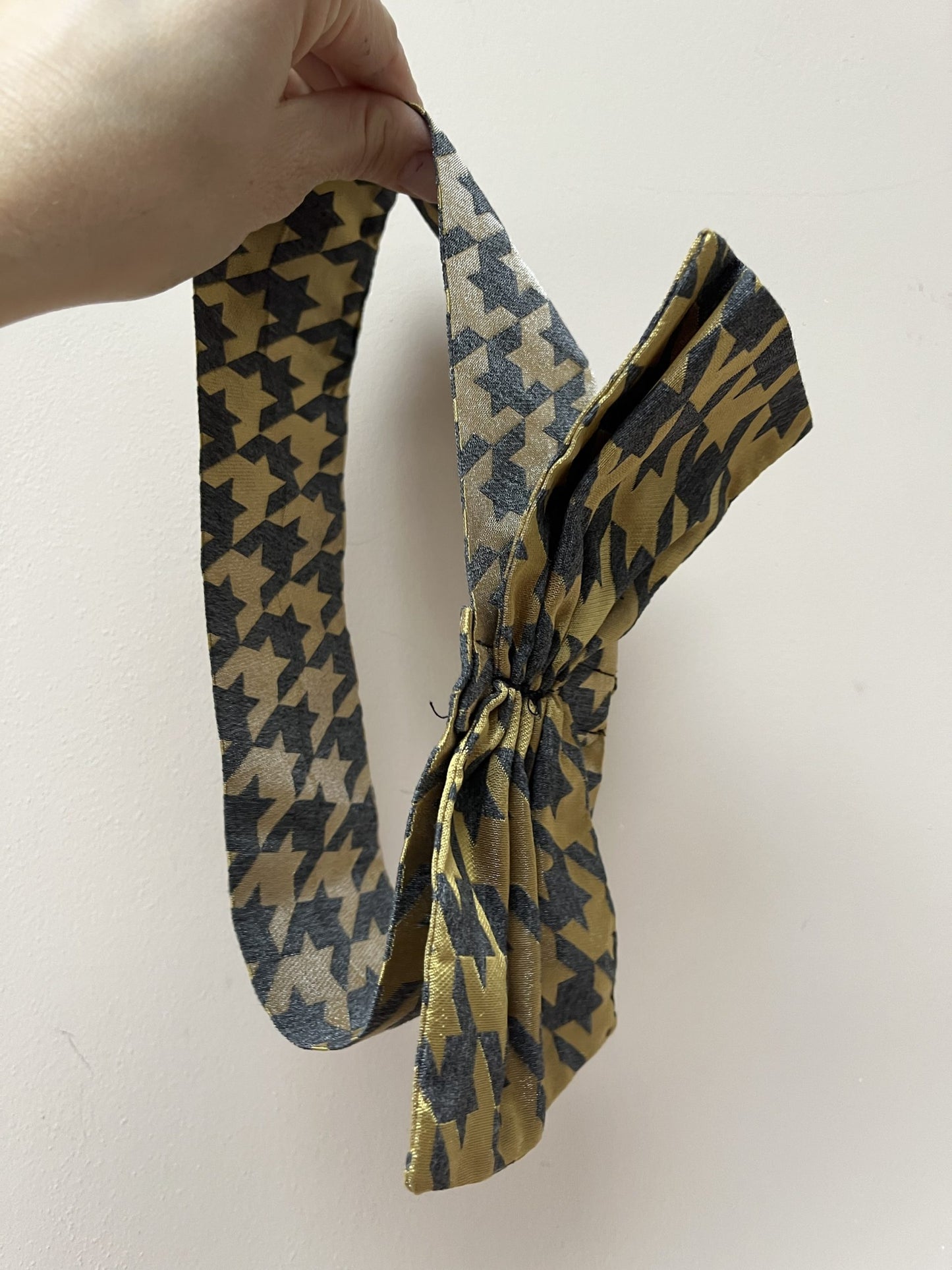 Gold and grey houndstooth headband with bow