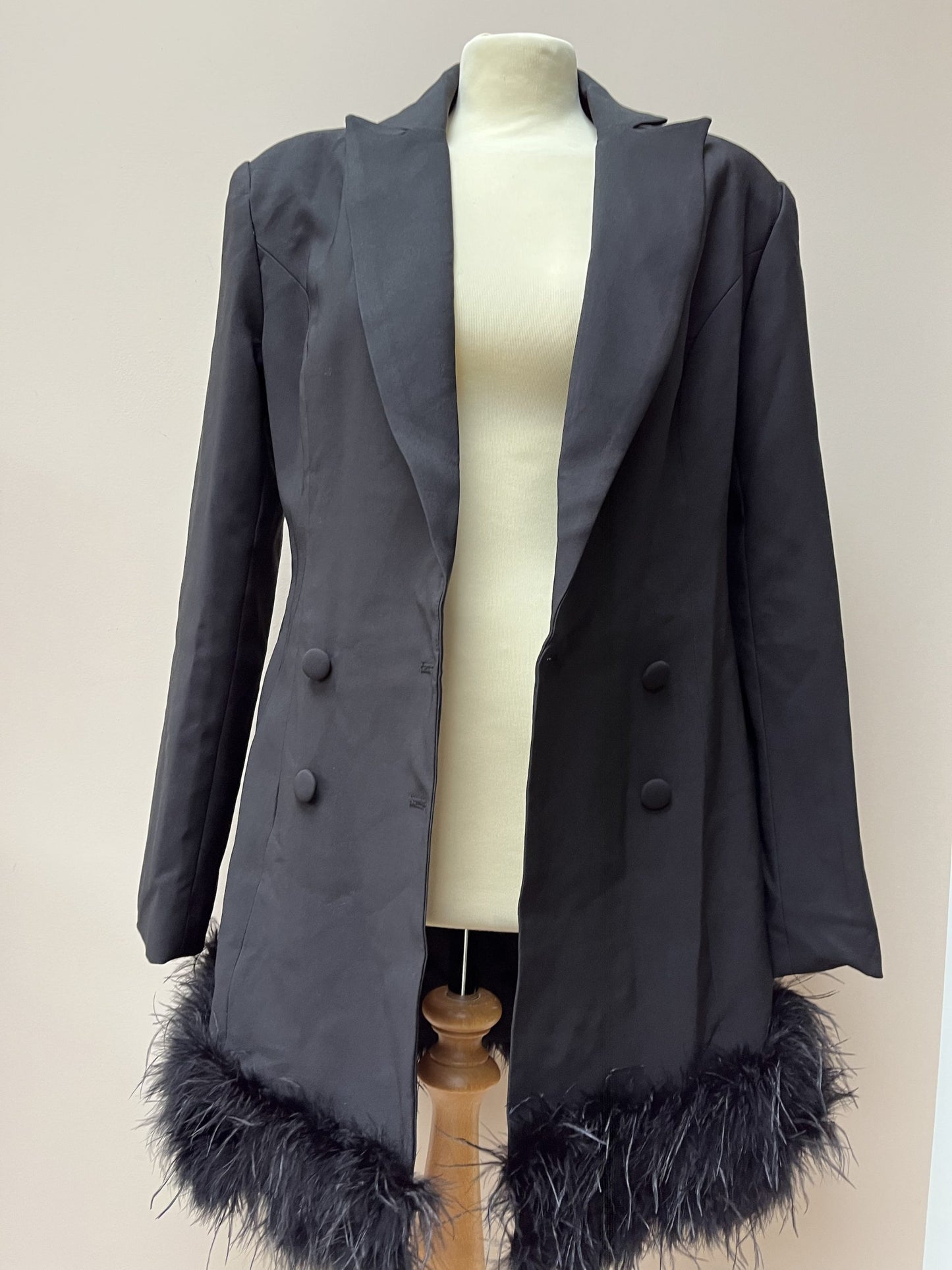 Black tuxedo style dress or jacket with feather hem. Size 12