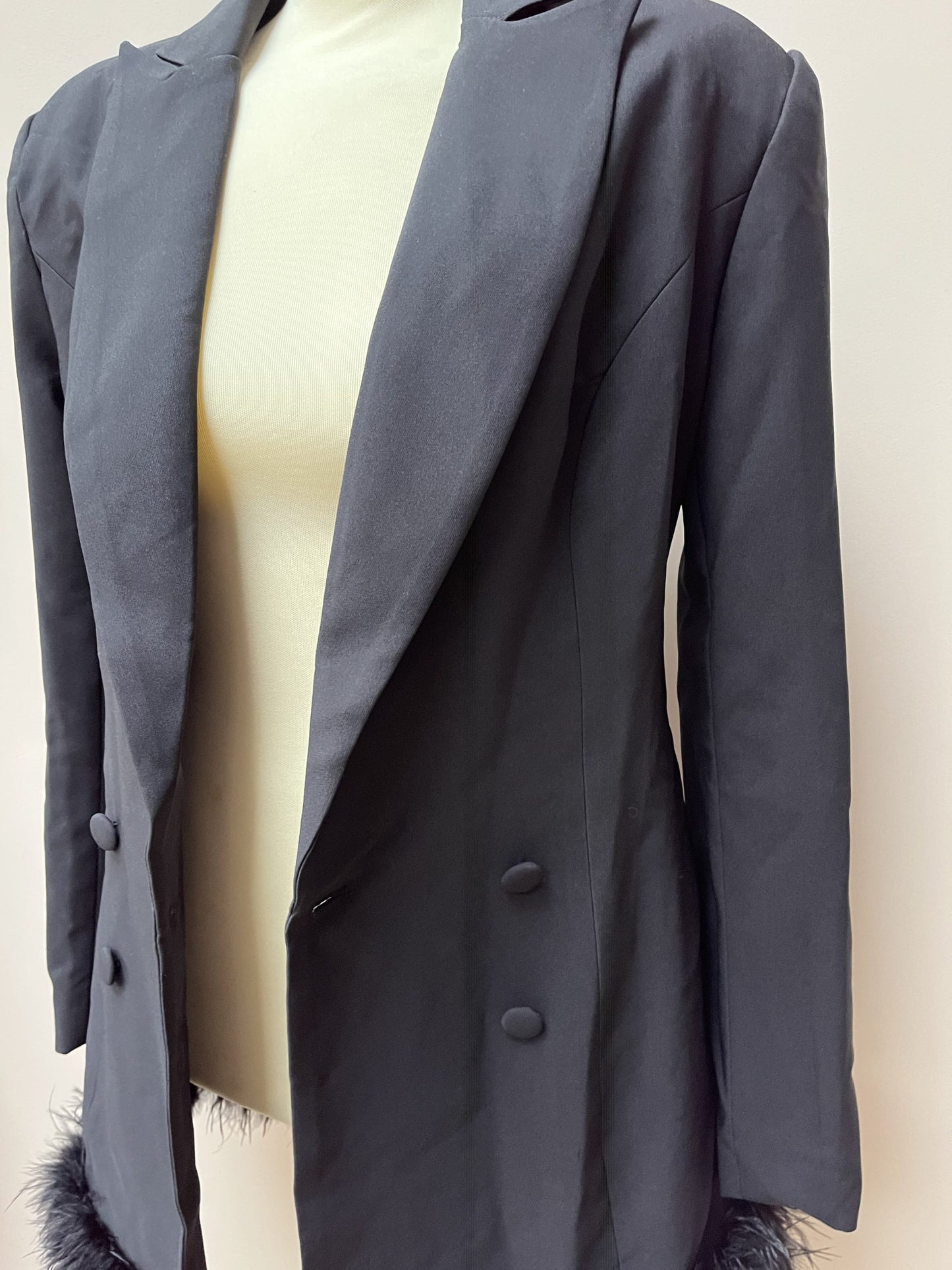 Black tuxedo style dress or jacket with feather hem. Size 12