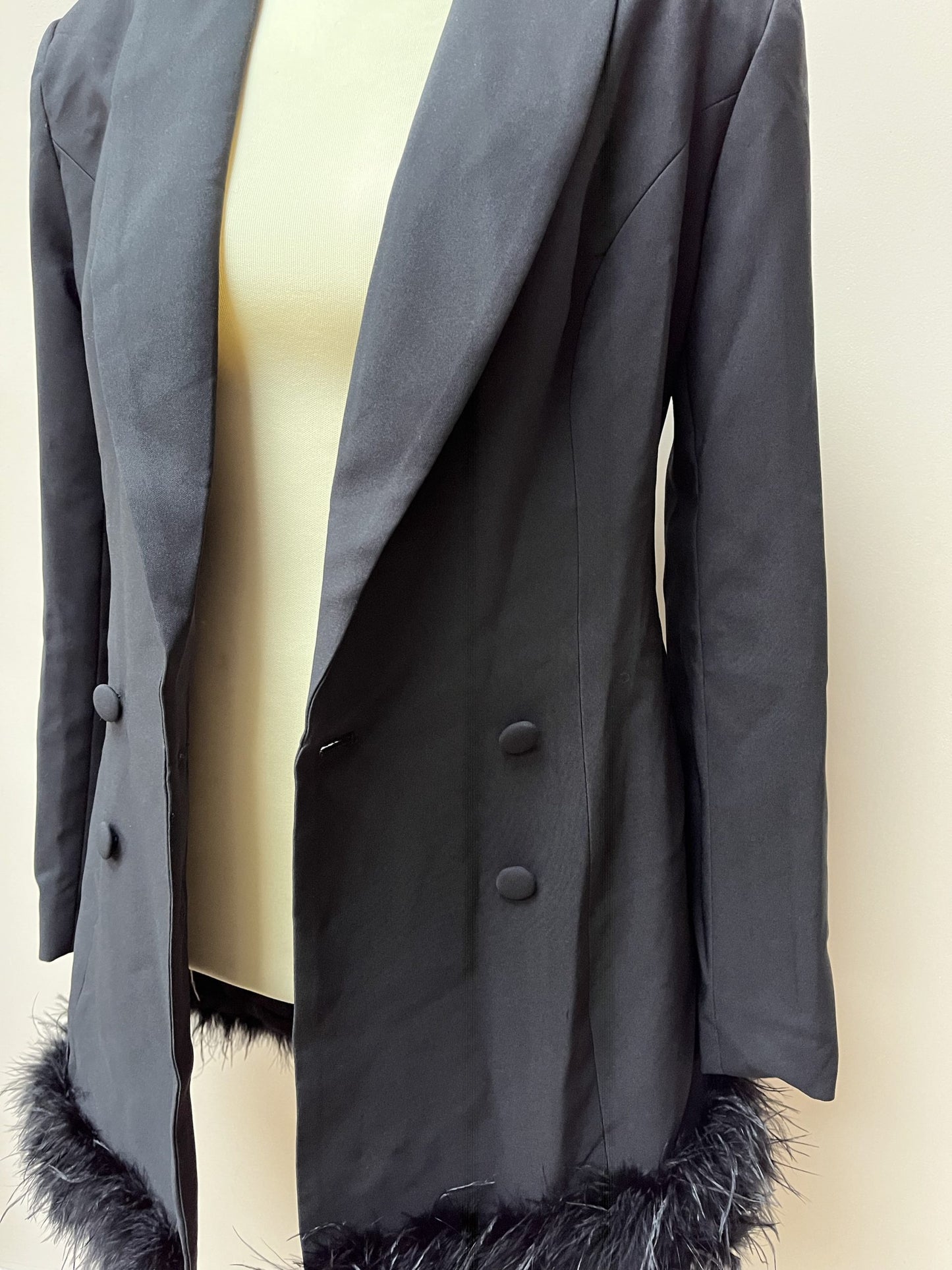 Black tuxedo style dress or jacket with feather hem. Size 12