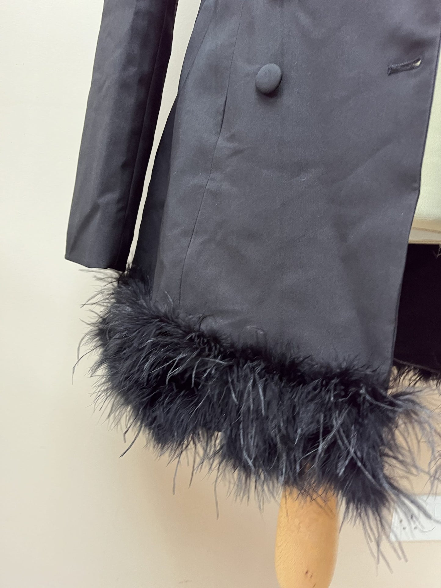 Black tuxedo style dress or jacket with feather hem. Size 12