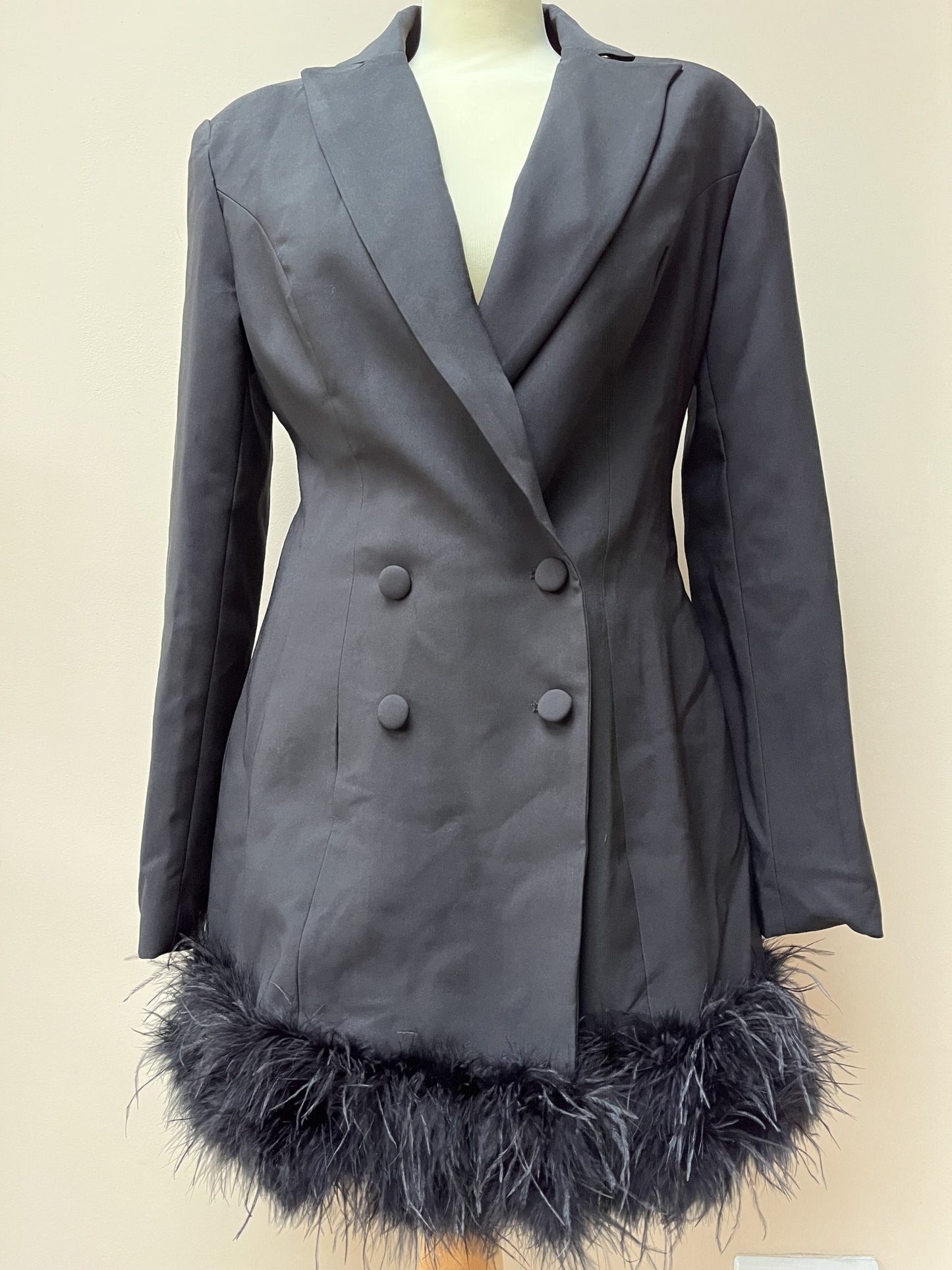 Black tuxedo style dress or jacket with feather hem. Size 12