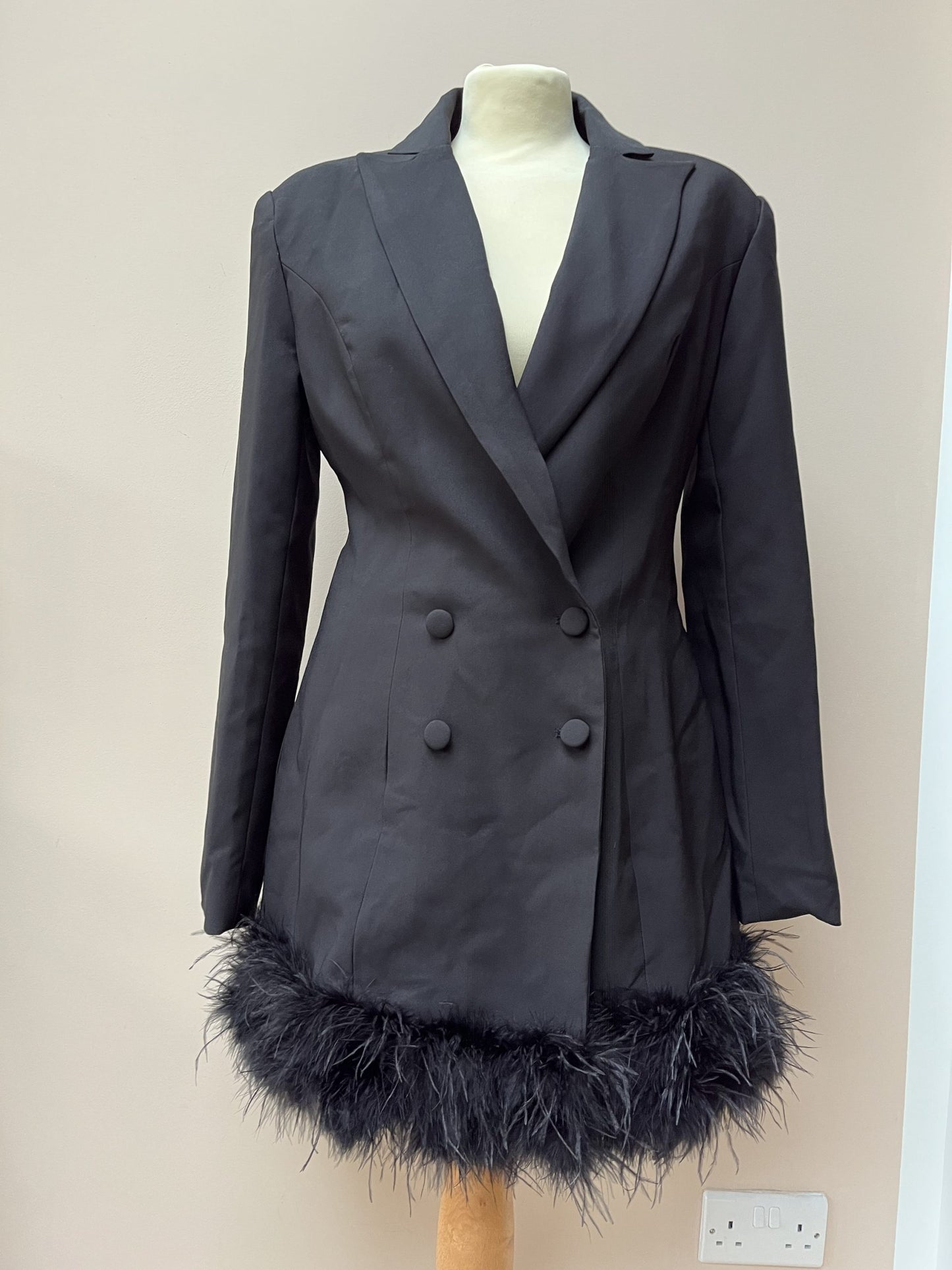 Black tuxedo style dress or jacket with feather hem. Size 12
