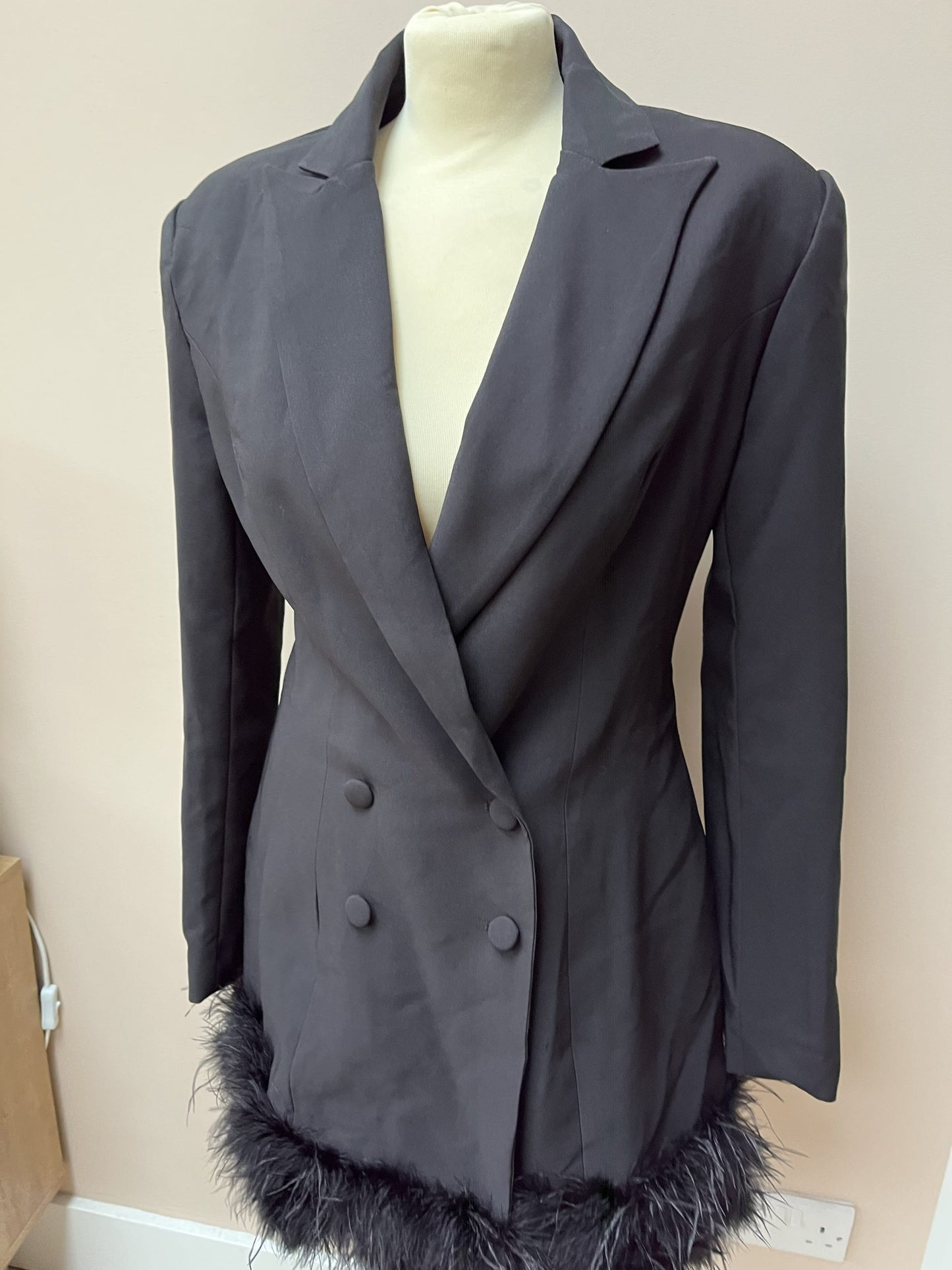 Black tuxedo style dress or jacket with feather hem. Size 12