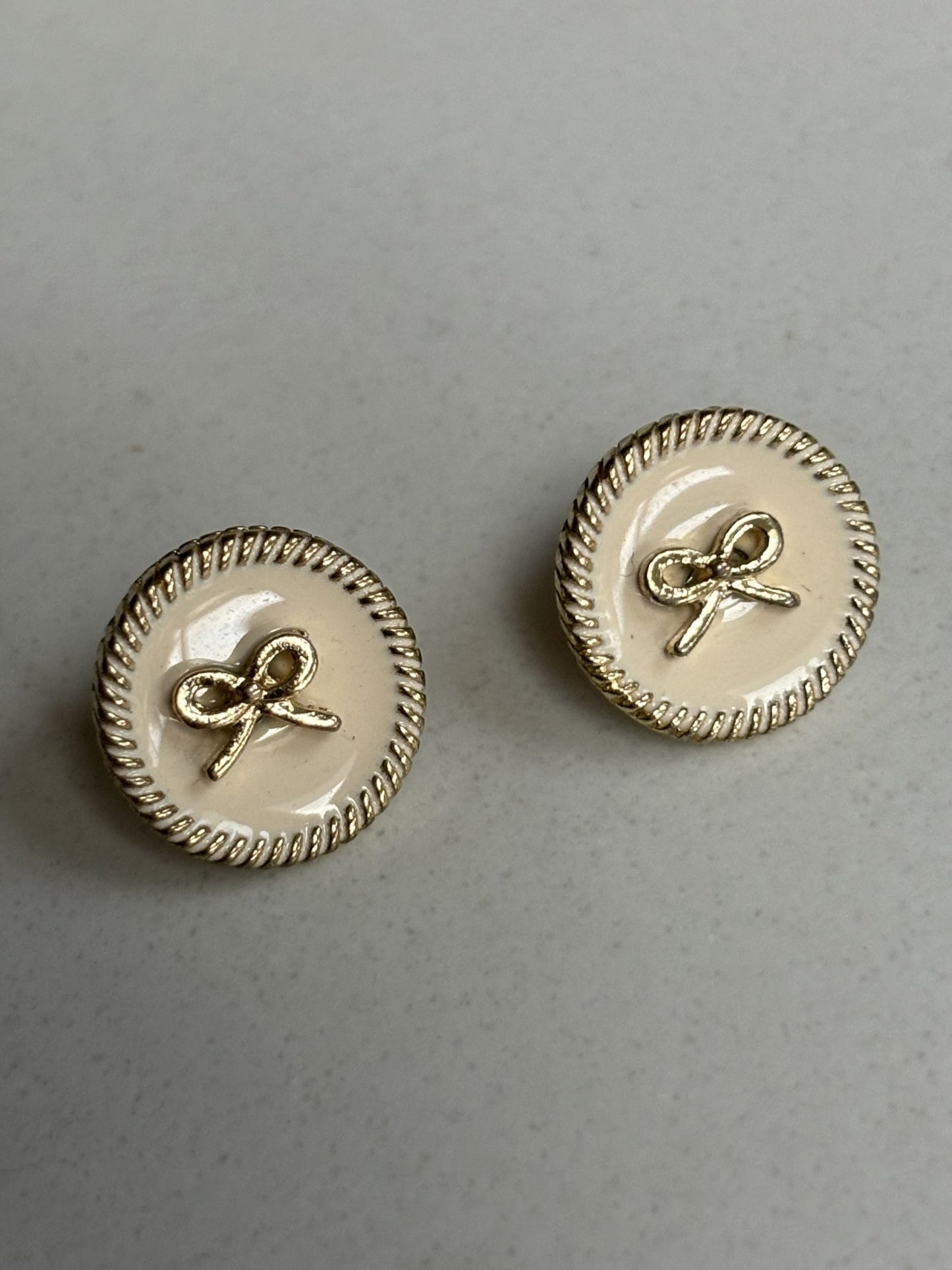 Gold bow and pale pink stud earrings